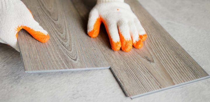 Freshly finished natural oak hardwood flooring spanning a bright living space with white sofa, neutral walls, and open sightline into a modern kitchen—highlighting smooth transitions and cohesive design.